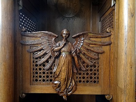 An angel on a confessional in a Roman Catholic church in Warsaw as a metaphor of the seal of confession