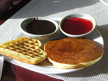 Pancake and waffle, served with sauces. Photo ...