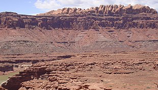 The Permian through Jurassic stratigraphy of the Colorado Plateau area of southeastern Utah that makes up much of the famous prominent rock formations in protected areas such as Capitol Reef National Park and Canyonlands National Park. From top to bottom: Rounded tan domes of the Navajo Sandstone, layered red Kayenta Formation, cliff-forming, vertically jointed, red Wingate Sandstone, slope-forming, purplish Chinle Formation, layered, lighter-red Moenkopi Formation, and white, layered Cutler Formation sandstone. Picture from Glen Canyon National Recreation Area, Utah. SEUtahStrat.JPG