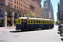 Veteran San Francisco streetcar 130 was built for Muni in 1914, and operates in the livery it carried in 1939. San Francisco 130 at foot of Market.jpg