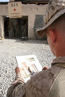 Sgt. Kristopher J. Battles, sketching while on active duty in Iraq. SgtBattles Iraq.jpg