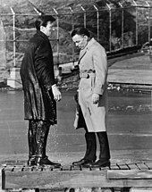 Shaw with Major Marco after jumping into a lake in Central Park when his programming was accidentally triggered Sinatra and Harvey in Manchurian Candidate NYWTS.jpg