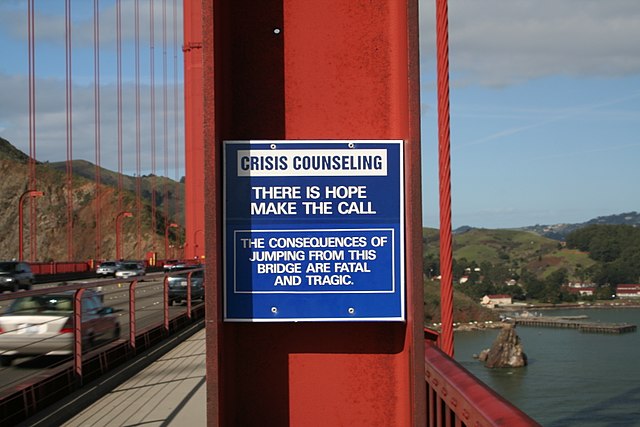 Crisis hotline sign at the Golden Gate Bridge