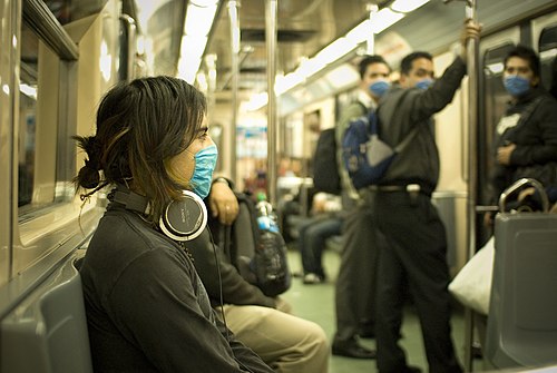 People in Mexico City wear masks on a train due to the swine flu outbreak throughout the surrounding region