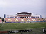 Национальный стадион Та'Кали Main Tribune.jpg