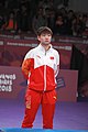 Deutsch: Tischtennis bei den Olympischen Jugend-Sommerspielen 2018: Tag 4, 10. Oktober 2018, Mädchen-Einzel, Siegerehrung - Gold: Yingsha Sun (CHN), Silber: Miu Hirano (JPN), Bronze:Andreea Dragoman (ROU)); Medaillen überreicht durch IOC-Mitglied Ching-kuo Wu (TPE), Maskottchen überreicht durch ITTF-Vize-Präsident Masahiro Maehara (JPN) English: Fencing at the 2018 Summer Youth Olympics at 10 October 2018 – Girls' single medail ceremony – Gold: Yingsha Sun (CHN), Silber: Miu Hirano (JPN), Bronze:Andreea Dragoman (ROU)); Medal presenter: IOC member Ching-kuo Wu (TPE), Mascot presenter: Vice-President Executive of the ITTF Masahiro Maehara (JPN)