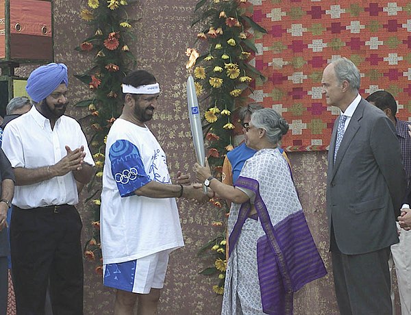 Sheila Dikshit handing over the Olympic Torch to Indian Olympic Association president Suresh Kalmadi at the beginning of the Olympic Torch Relay in 20