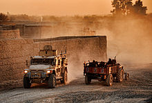 ISAF and Afghan civilian vehicles on Route Trident Troops in Husky Vehicle Pass Local Civilians on Route Trident in Afghanistan MOD 45152226.jpg