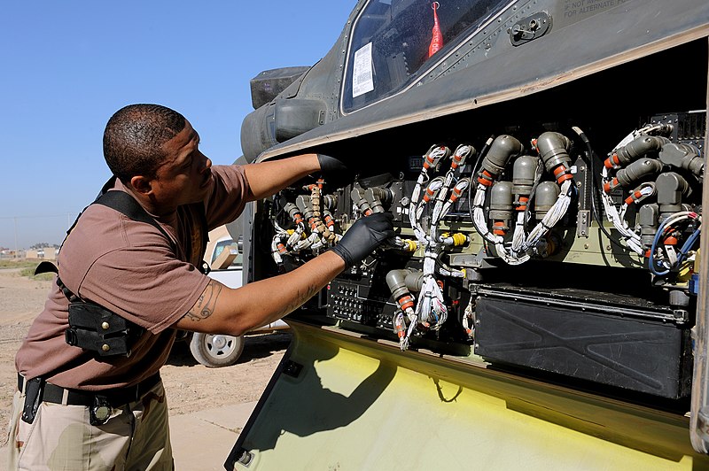 File:US Navy 100415-F-5214M-005 Petty Officer 2nd Class Lavonderick Campbell, a Navy customs administrator, inspects behind a front panel of an AH-64 Apache helicopter at Joint Base Balad, Iraq.jpg