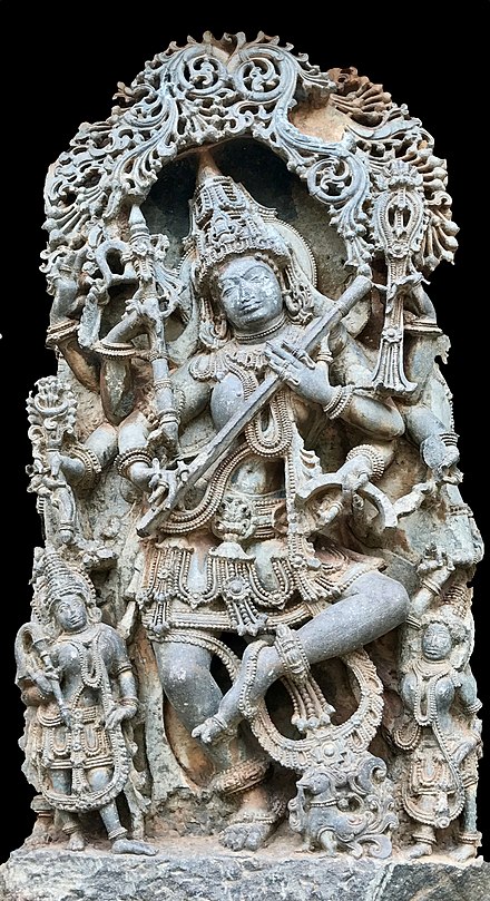 Dancing Sarasvati with eight-hands (above) is depicted in three panels of the Hoysaleswara temple, Halebid Karnataka (c. 1150 CE). One of these is shown above. She is in a classical Indian dance posture, and in one of her eight hands she holds a pen, a palm leaf manuscript, a musical instrument and the tools of major arts. The shilpins thus depicted her as the goddess of knowledge and all arts.