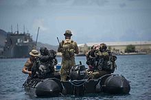 Clearance Divers prepare to enter the water during a Very Shallow Water (VSW) scenario during Exercise Tricrab 2016 in Guam 160517-N-ON977-026 Exercise Tricrab 2016 Clearance Divers.jpg