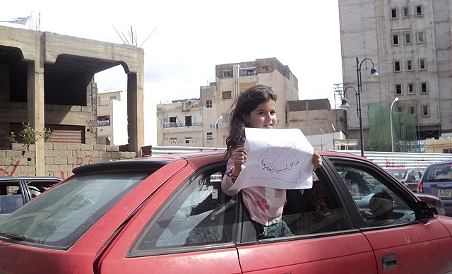 A girl in Benghazi with a placard saying that the Libyan tribes are united, on 23 February 2011.