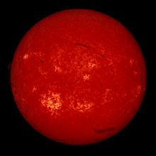 When observed in the Ha spectral line, the chromosphere appears deep red. BBSO full-disk H-alpha 2002-07-26 153931 color.png