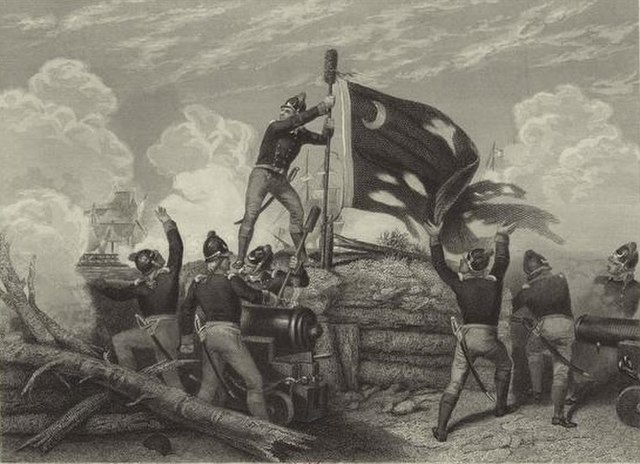 The Moultrie Flag (also known as the Liberty Flag) being raised over Fort Moultrie, after the Patriot victory in the Battle of Sullivan's Island.