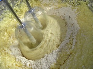 Beating flour into cake mixture.JPG
