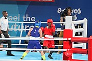 Deutsch: Boxen bei den Olympischen Jugendspielen 2018 Tag 12, 18. Oktober 2018 - Finale Fliegengewicht Mädchen – Martina La Piana (Italien, blau) schlägt Adijat Gbadamosi (Nigeria, rot) 5-0; Ringrichter ist James Beckles (Trinidad und Tobago). English: Boxing at the 2018 Summer Youth Olympics on 18 October 2018 – Girl's flyweight Gold Medal Bout - Martina La Piana (Italy, blue) beats Adijat Gbadamosi (Nigeria, red) 5-0; Referee is James Beckles (Trinidad and Tobago). Español: Boxeo en los Juegos Olímpicos Juveniles de Verano de 2018 en 18 de octubre de 2018 - Combate a medalla de oro de peso mosca para mujeres: Martina La Piana (Italia, azul) le gana a Adijat Gbadamosi (Nigeria, roja) 5-0; El árbitro es James Beckles (Trinidad y Tobago).