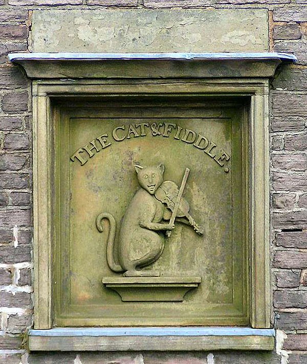 Relief sculpture on wall of the Cat and Fiddle public house. The pub name derives from the nursery rhyme.