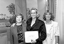 Cybill Shepherd inside the "Smithsonian Castle" during the filming of Chances Are, where she plays a Smithsonian curator. She is presented with an honorary Resident Associate Program membership, by (l.) National Museum of American History (NMAH) Curator Edith Mayo and NMAH Director of External Affairs, Marilyn Lyons Cybill Shepherd at Castle.jpg