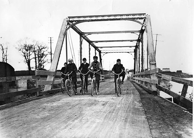 Boys cycling across Lakeshore Road bridge at Mimico (ca. 1907)