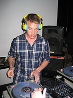 Diplo playing at a DJ booth.