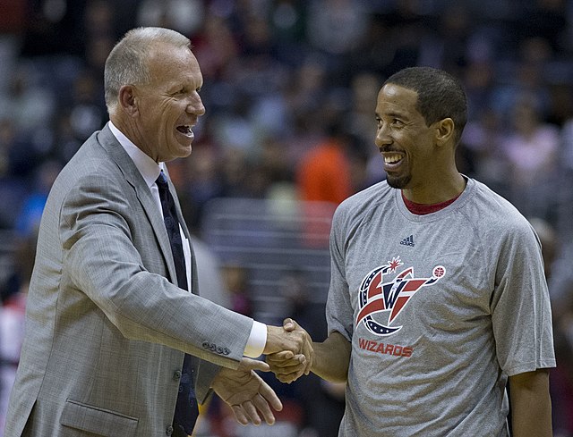 Collins speaks with Andre Miller in 2014