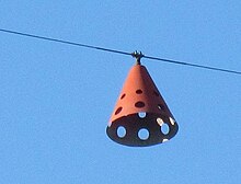 An aviation obstruction marker on a high-voltage overhead transmission line reminds pilots of the presence of an overhead line. Some markers are lit at night or have strobe lights. High voltage transmission line aviation obstruction marker.jpg