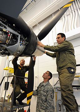 Italian air force Chief Warrant Officer Lorenzo Scafuto, right, and Staff Sgt. Marco Redavide, center, work together on an MQ-9 Reaper aircraft while receiving instructions from U.S. Air Force Master Sgt. Scott 110920-F-IF667-043