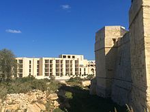 Ruins of the hotel with Saint Thomas Tower to the right, as seen in 2016 Jerma Palace Hotel, Marsascala.jpeg