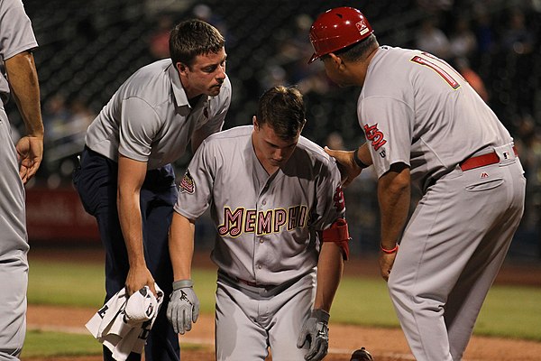 Lane Thomas of the Memphis Redbirds is evaluated for injury after being hit by a pitch in a 2019 game.