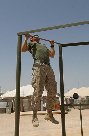 A marine performs pull-ups
