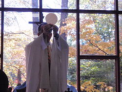 A Legionary priest celebrating the Eucharist at an ECyD camp at Camp Otyokwah in Ohio. Mass otyokwah.jpg