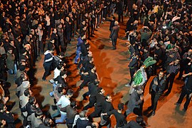 Moving in a circle, mourners strike their chests (sina-zani) in Iran