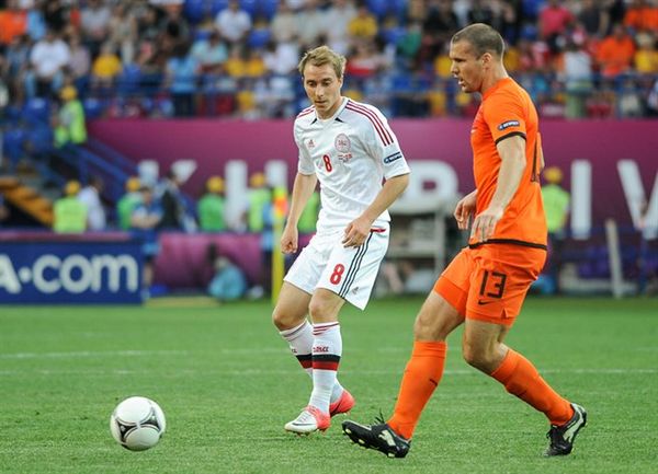 Vlaar (right) making a pass as, Denmark's Christian Eriksen looked on at the UEFA Euro 2012.