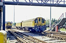 Battery electric works locomotives 20, 27, and 32 in sidings at Neasden Depot in 1988. Neasden 1988 Battery Loco 32 and 20 behind.jpg