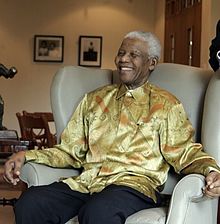 Mandela on a visit to Australia in 2009; he is wearing one of the brightly coloured garments that became known as Madiba shirts