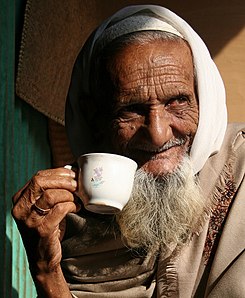 Old Bangladeshi drinking tea cropped.jpg
