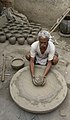 Image 4 Potter Photo: Yann A potter at work in Jaura, Madhya Pradesh, India. Pottery, defined by ASTM International as "all fired ceramic wares that contain clay when formed, except technical, structural, and refractory products", originated during the Neolithic period. More selected pictures