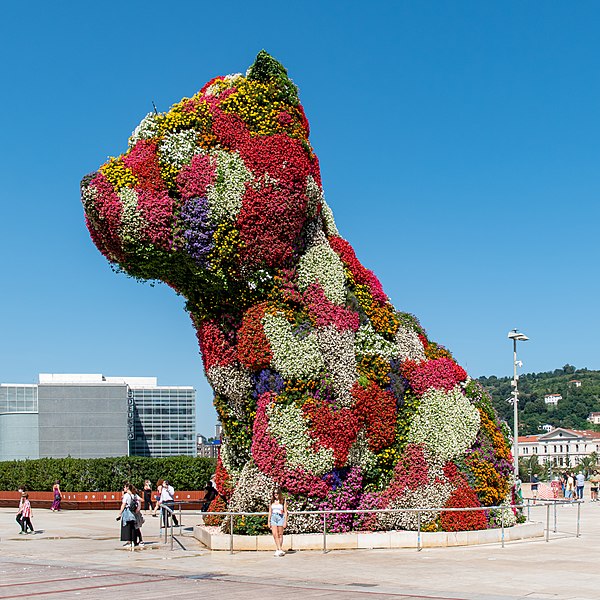 Puppy by Jeff Koons (2010) is a self-aware display of kitsch, specifically as a combination of opulence and cuteness.