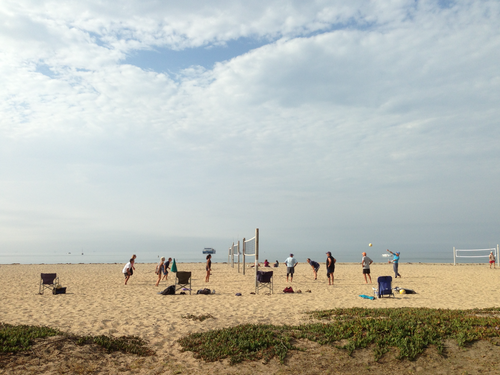 People playing volleyball on a beach