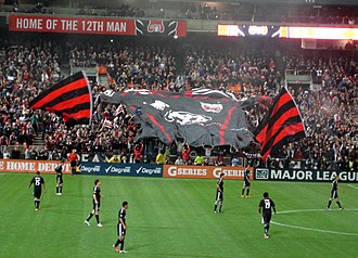 Screaming Eagles celebrating a goal with a large jersey shaped overhead banner. Screaming eagles jersey tifo 2011APR10.jpg