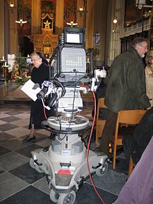 Outside Broadcast camera on a Vinten pedestal. Note the pneumatic wheels. TV-camera-1.jpg