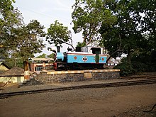 Blu-and-white locomotive on a pedestal