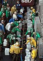 US Navy 050106-N-4336M-294 Crew members aboard USS Abraham Lincoln (CVN 72) fill jugs with purified water from a Potable Water Manifold.jpg
