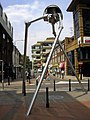 Image 64Statue of a tripod from The War of the Worlds in Woking, England, the hometown of author H. G. Wells. The book is a seminal depiction of a conflict between mankind and an extraterrestrial race. (from Culture of the United Kingdom)