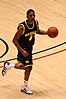 Male basketball player dribbling a basketball with blue uniform #4