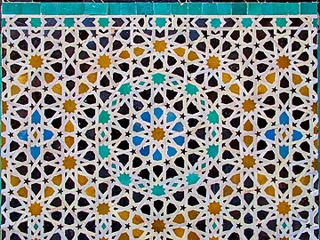 Complex geometric motifs in zellij (mosaic tilework) at the Bou Inania Madrasa in Fez (14th century, Marinid period)