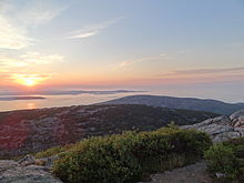 Sunrise with Dorr Mountain in the foreground, and the Atlantic Ocean in the background