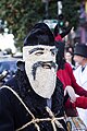 An actor playing the role of an old man wearing a homemade wool mask