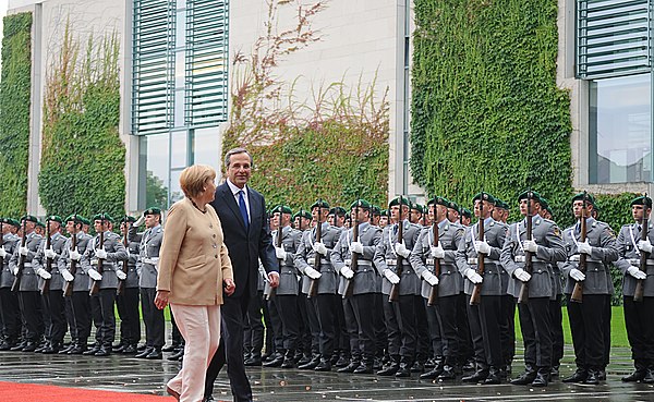 Wachbataillon personnel in Army uniforms perform the military honours for the German Chancellor Angela Merkel and Greek Prime Minister Antonis Samaras