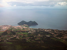 A view of Monte Brasil from the flanks of the Santa Bárbara volcano, showing the built-up urban sprawl of the city of Angra do Heroísmo